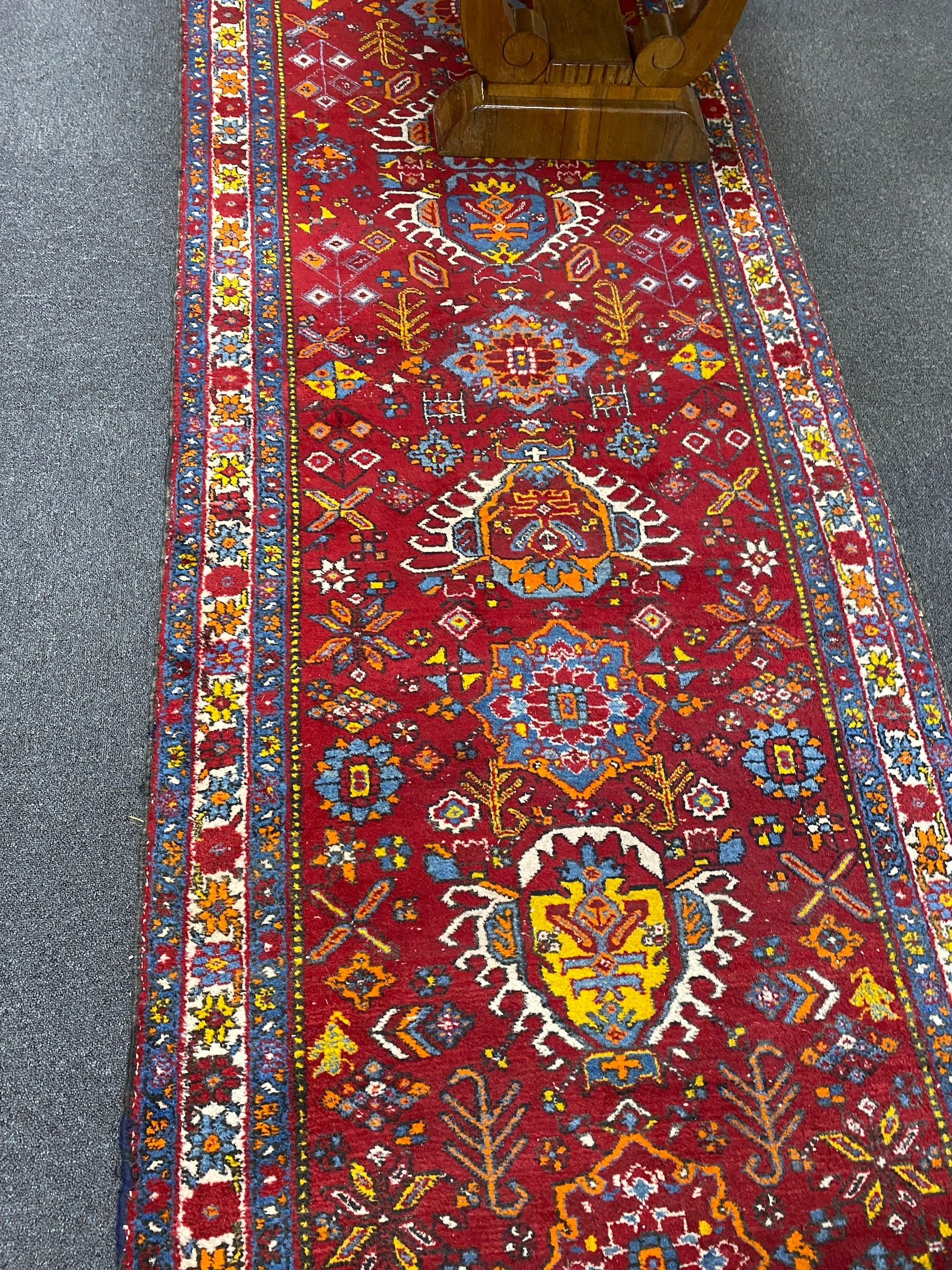 A North West Persian red ground runner, 426 x 100cm
